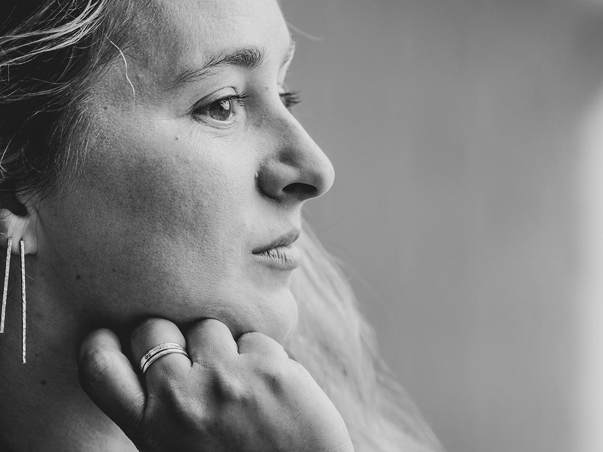 J Printz Designs Portrait of the artist, Jamie Printz, showing her profile with a hand on her chin.