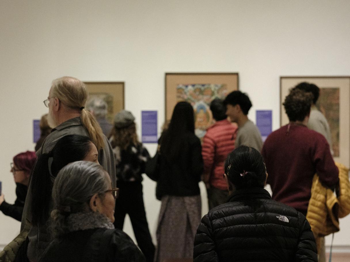 A group of people in a gallery.