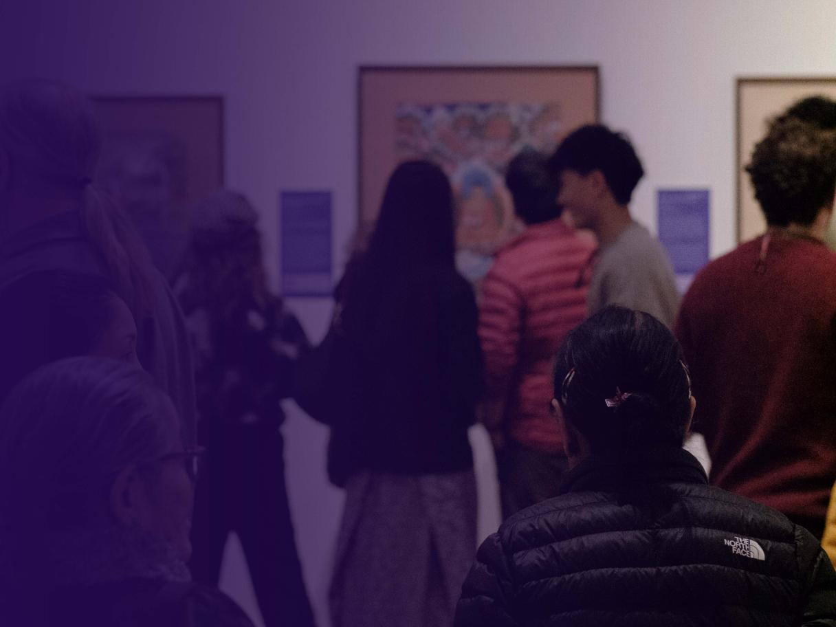 A photo of people in a gallery with a blue gradient overlaid on top.