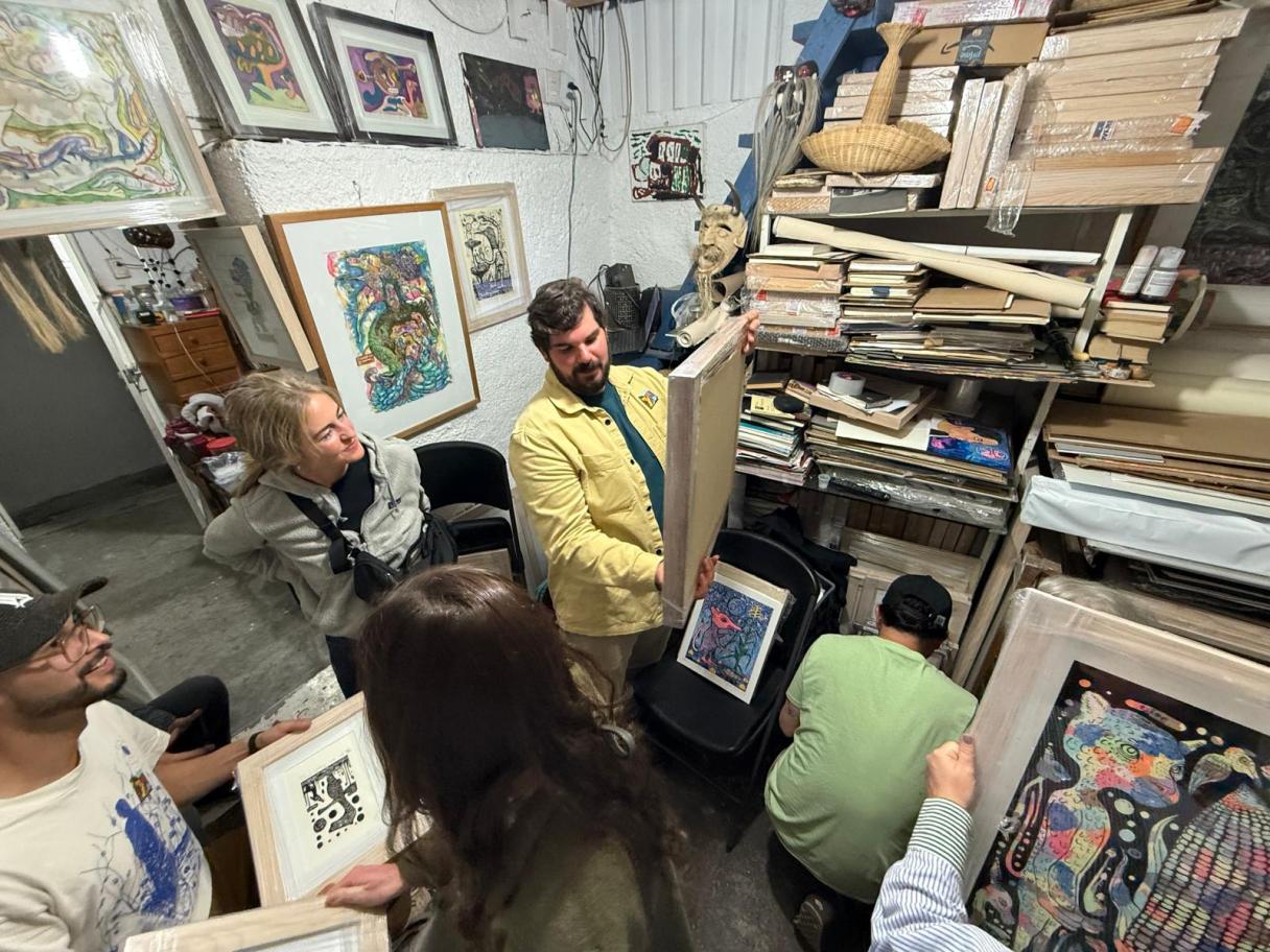 Peter Hay Studio Visit with Filogonio Naxín. Photo by Amy Jorgensen. Peter Hay looking at art in a studio.