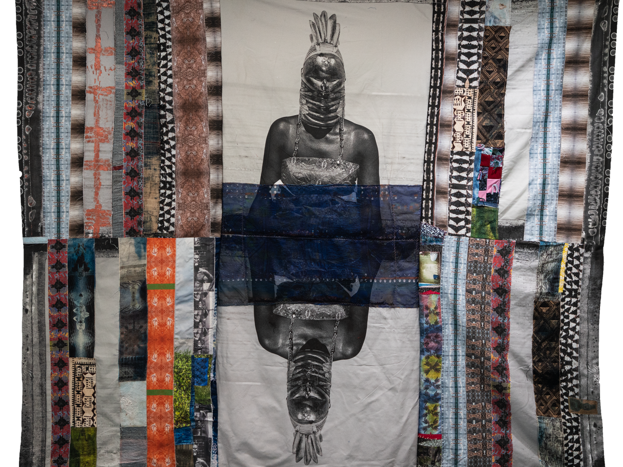 salt 17: Adama Delphine Fawundu A patchwork cloth tapestry with a print of a person in the middle.