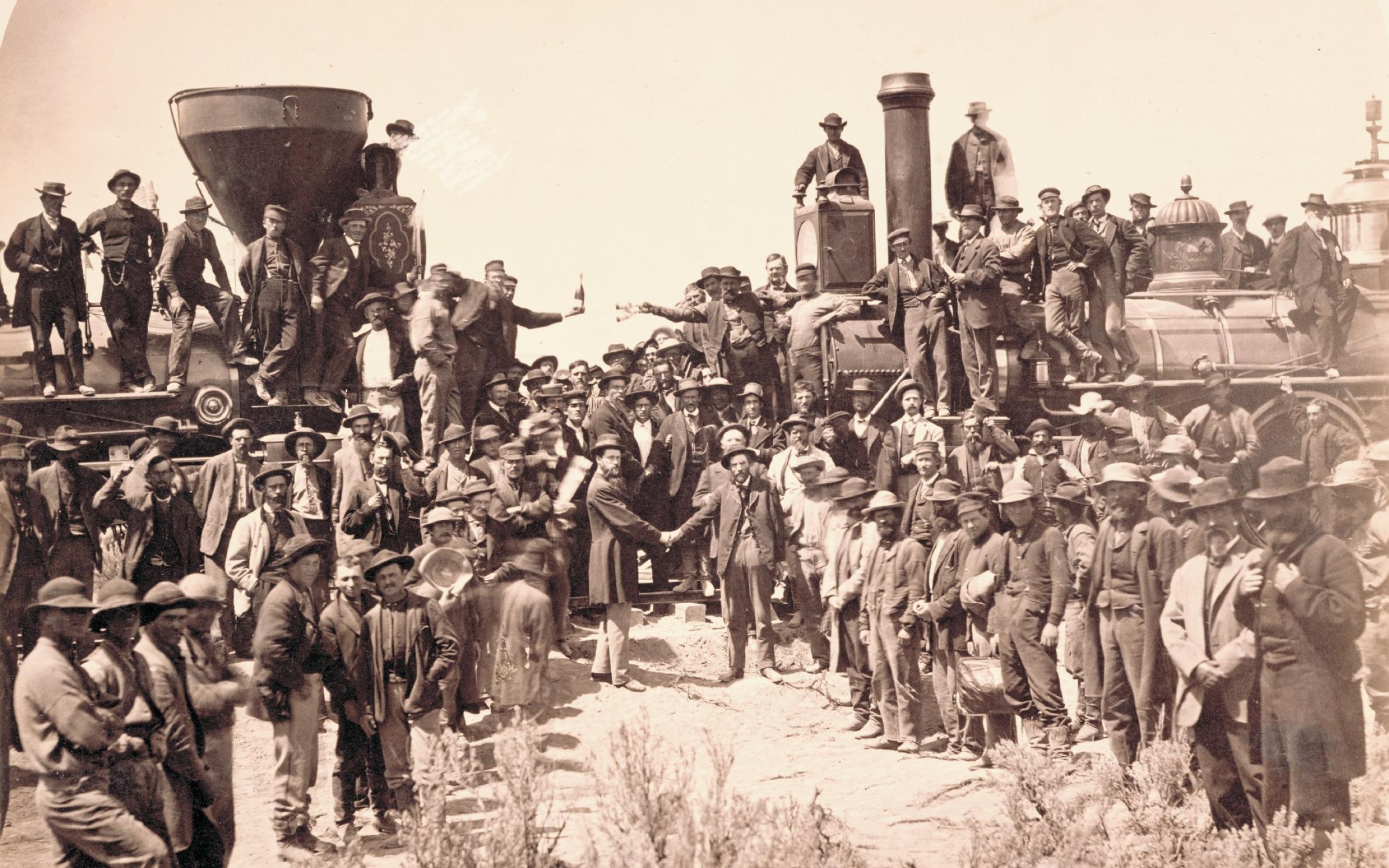 Andrew J. Russell (American, 1830­1902), East and West Shaking Hands at Laying Last Rail, 1869, albumen print, courtesy Union Pacific Railroad Museum. The ceremony spotlighted Union Pacific locomotive No. 119 meeting Central Pacific locomotive Jupiter. From left, shaking hands, are Samuel S. Montague, chief engineer of the Central Pacific Railroad, and General Grenville M. Dodge, chief engineer of the Union Pacific Railroad. 