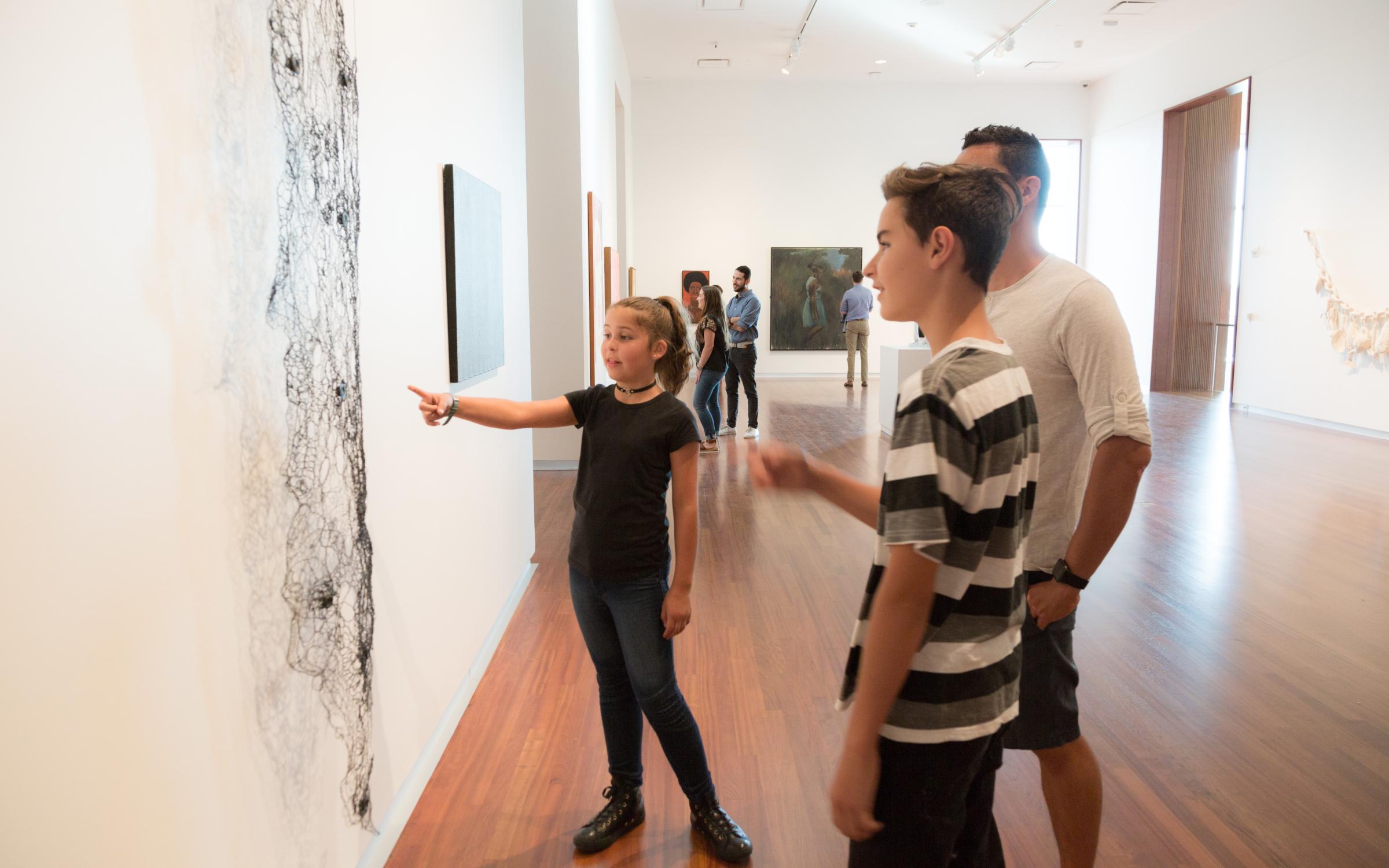 Families examining modern and contemporary art at the UMFA
