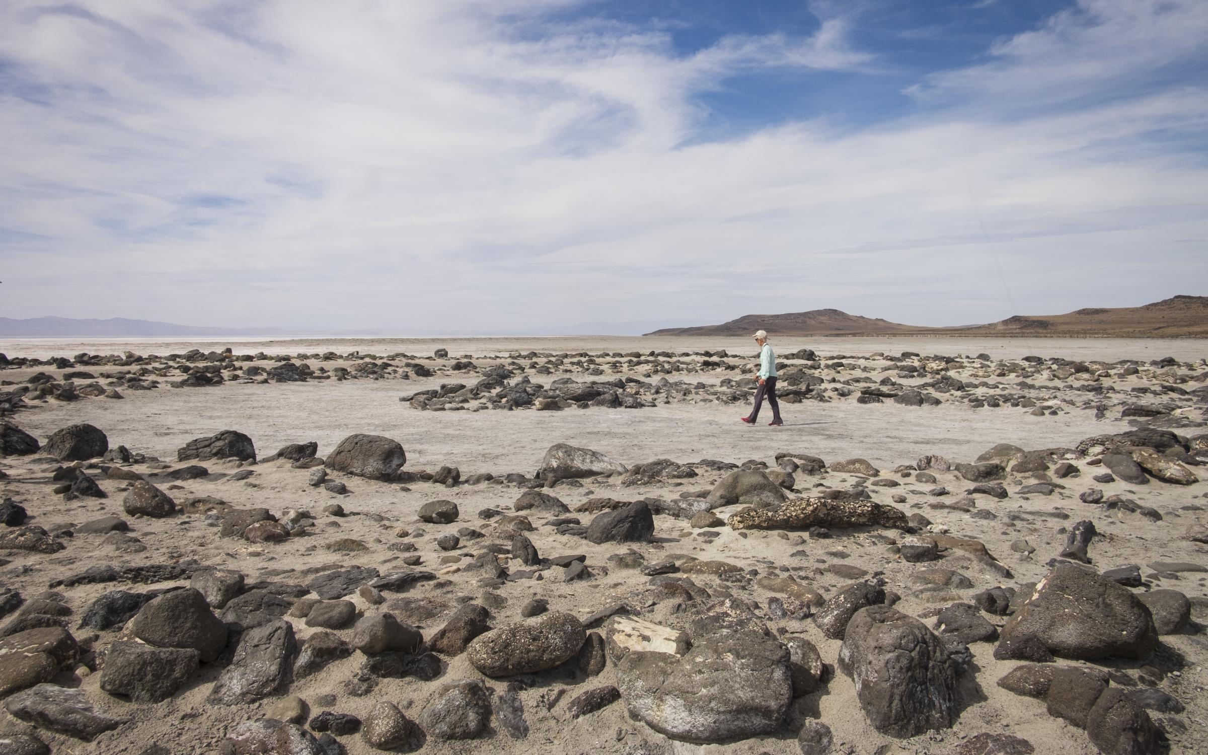 Visitor walks along Spiral Jetty at Rozel Point of Great Salt Lake