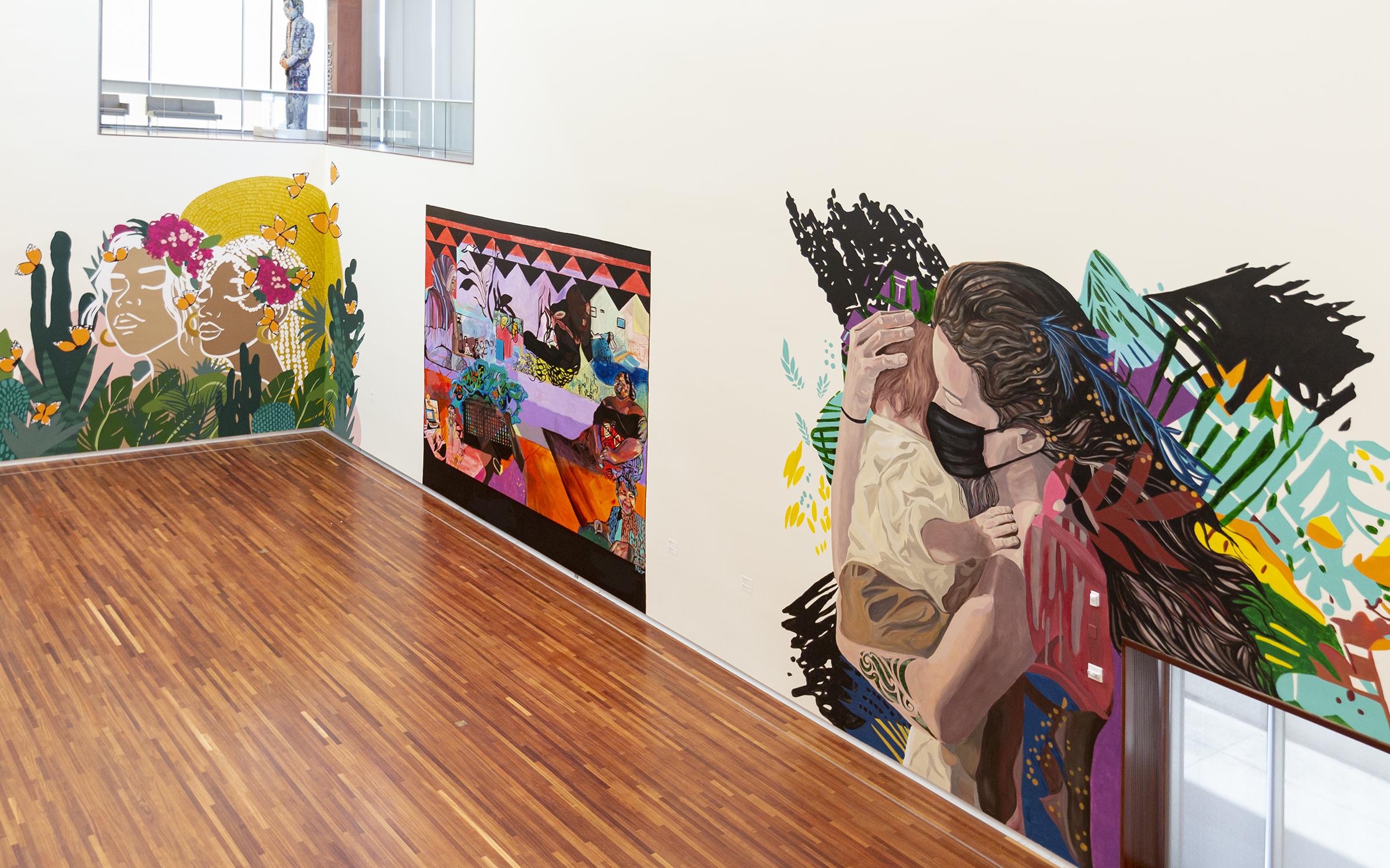 View looking from the second flood in to the UMFA's G.W. Anderson Family Great Hall, three of the murals from 2020:From here on out from left to right murals by Ella Rises, Vaimoana Niumeitolu, and Bill Louis. View looking from the second flood in to the UMFA's G.W. Anderson Family Great Hall, three of the murals from 2020:From here on out from left to right murals by Ella Rises, Vaimoana Niumeitolu, and Bill Louis.