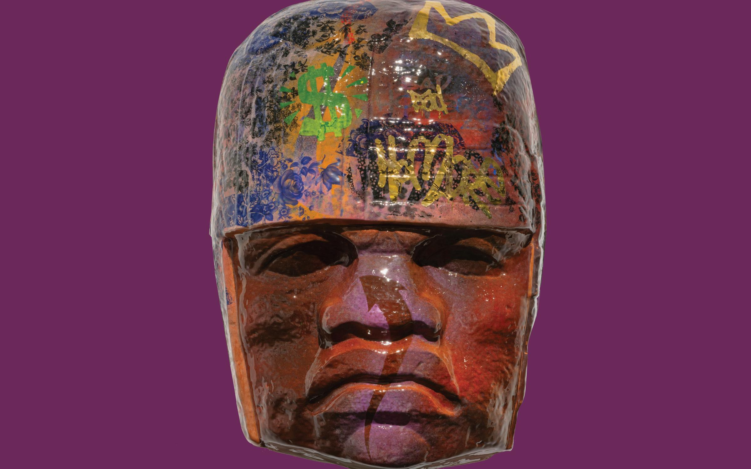 HoracioRodriguez (American, b. 1974),Colossal Head Series: Bad Hombre, 2021, slip-cast terracotta, ceramic decals, underglaze transfers, gold luster and glaze. Large Mesoamerican sculpture of a head with graffiti on it.