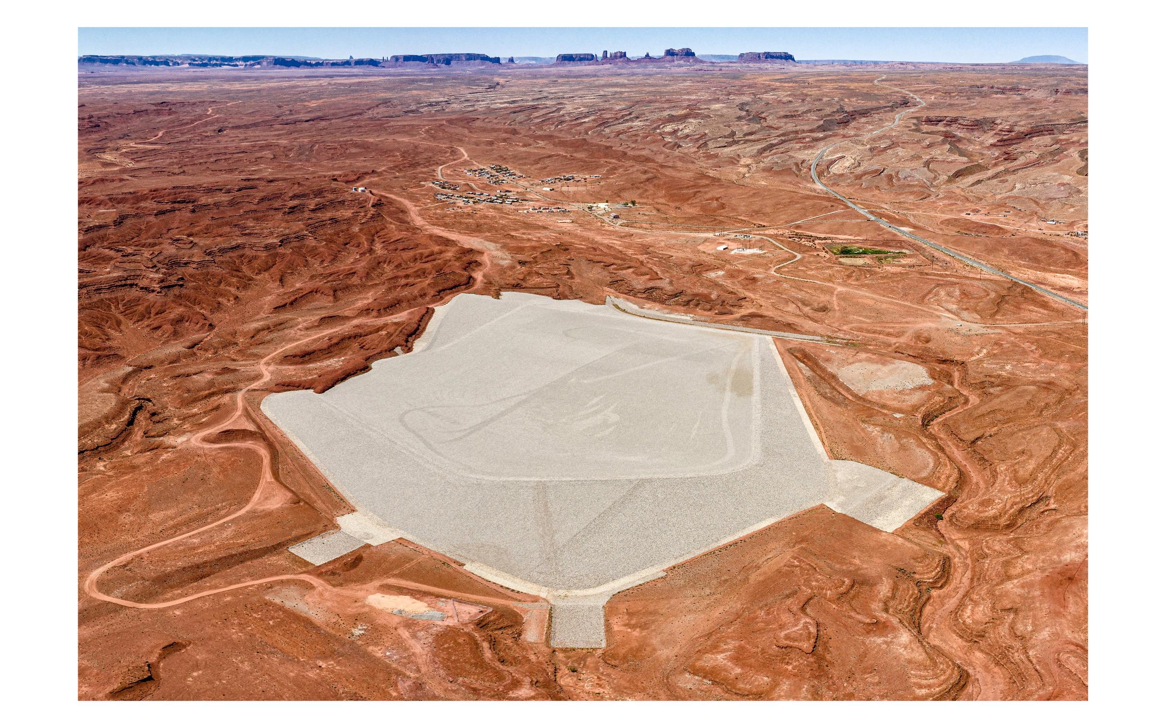 Will Wilson Diné, nacido en 1969, vive en Santa Fe, NM Mexican Hat Disposal Cell, Triptych, Halchita, Utah, Navajo Nation, 2019 Impresiones de pigmento de archivo A drone shot of a massive filled hexagon in an orange desert.