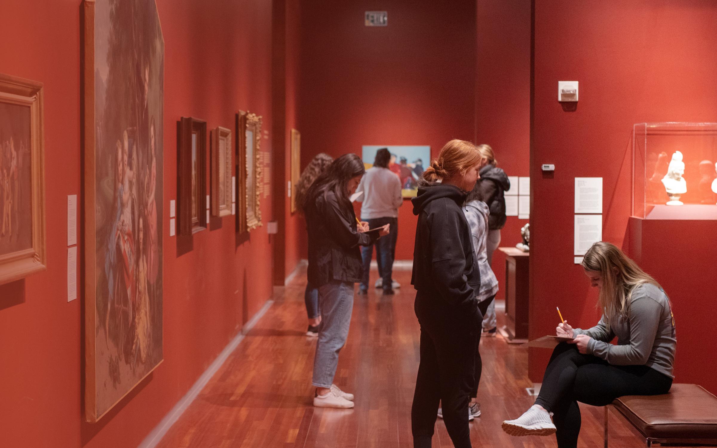 A group of people in the European gallery taking notes