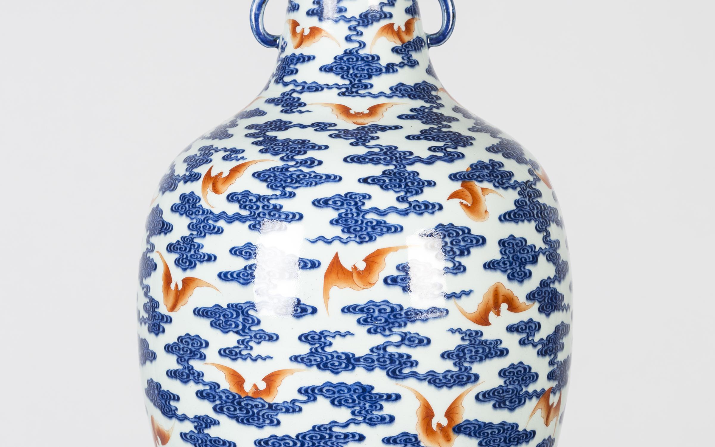IMPERIAL VASE WITH BATS AND CLOUDS A white and blue vase with orange bats