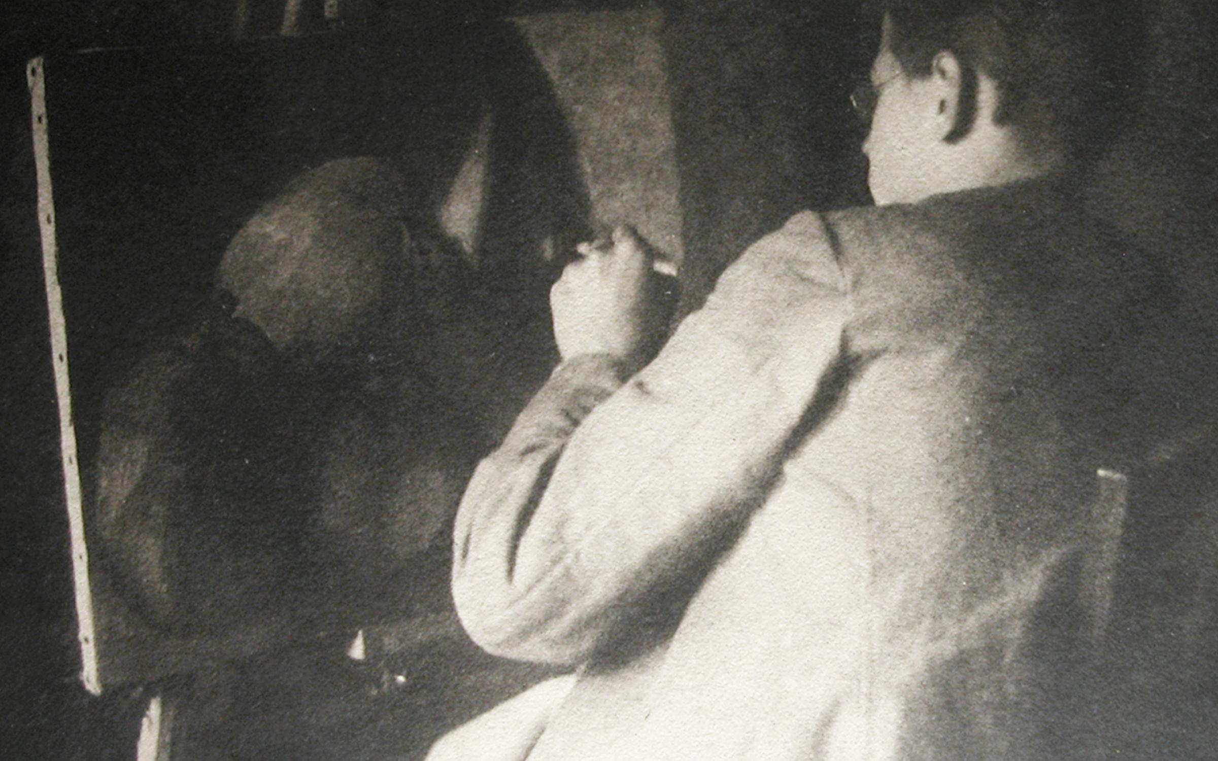 A black and white photograph of a man, Walter, sitting at an easel.