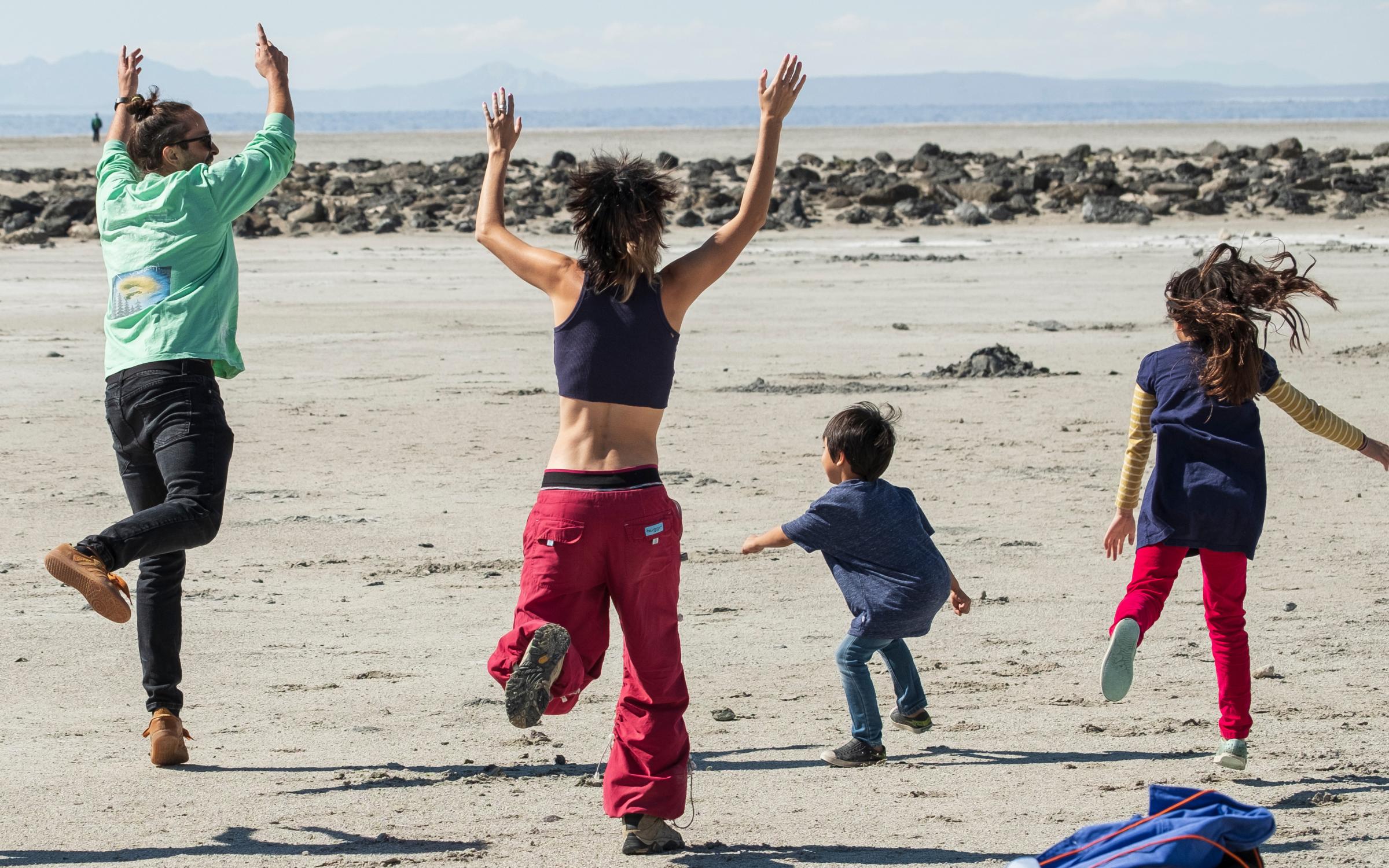 Spiral Jetty Meet-up A group of people jump and dance at the Spiral Jetty.