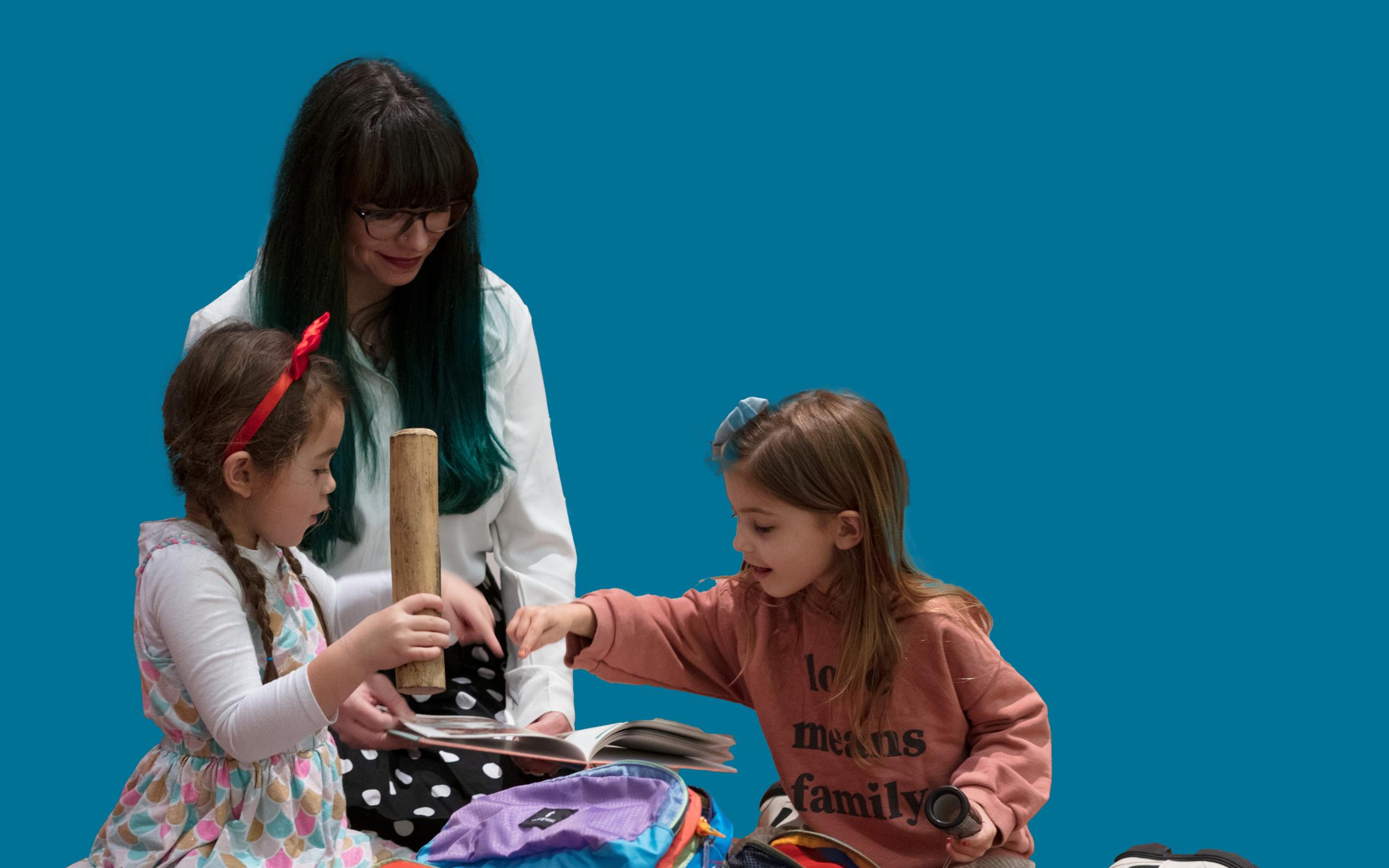 Sensory Friendly Evening A family sits on the floor using tools in a sensory backpack.