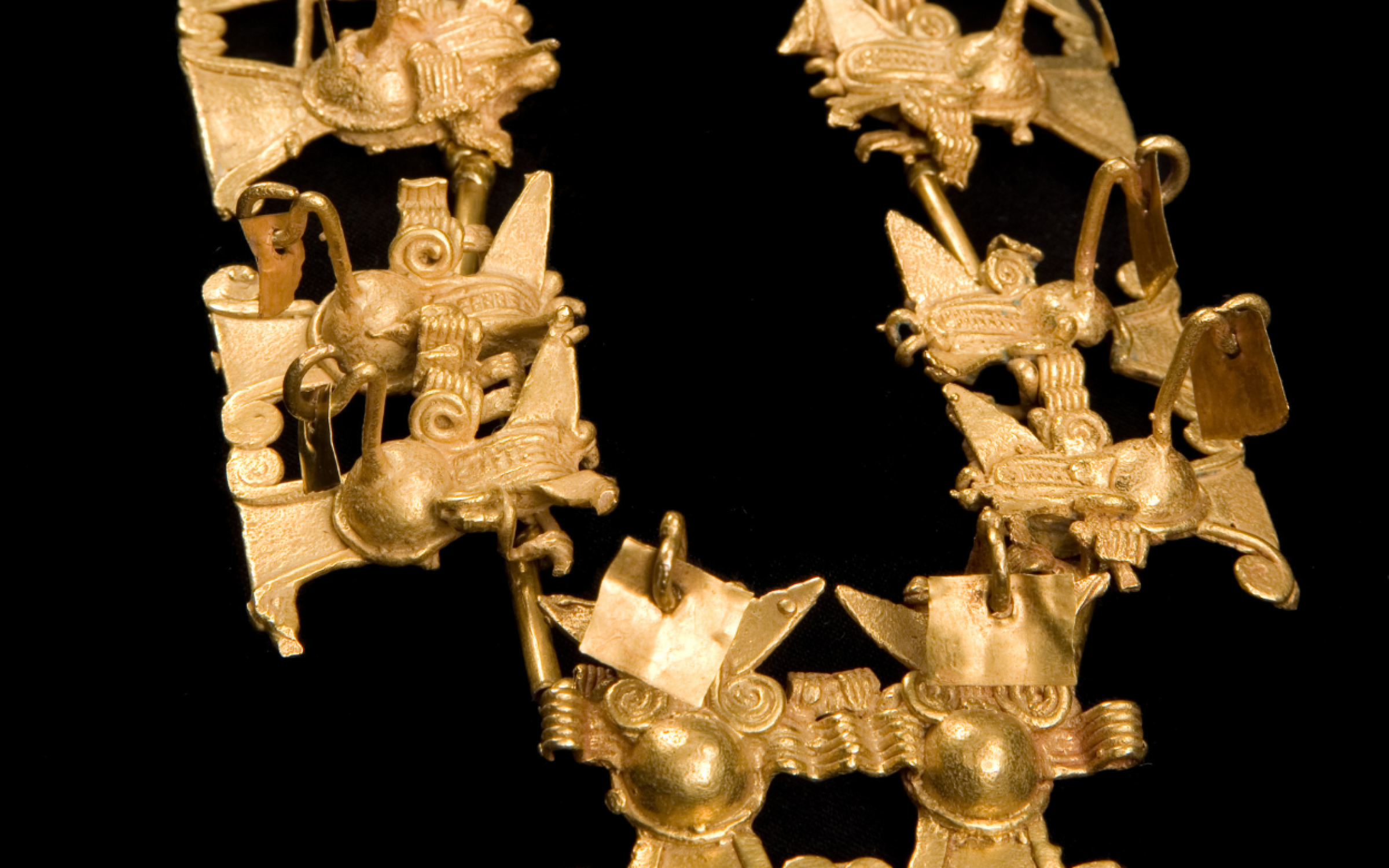 A golden necklace with double bat effigies.