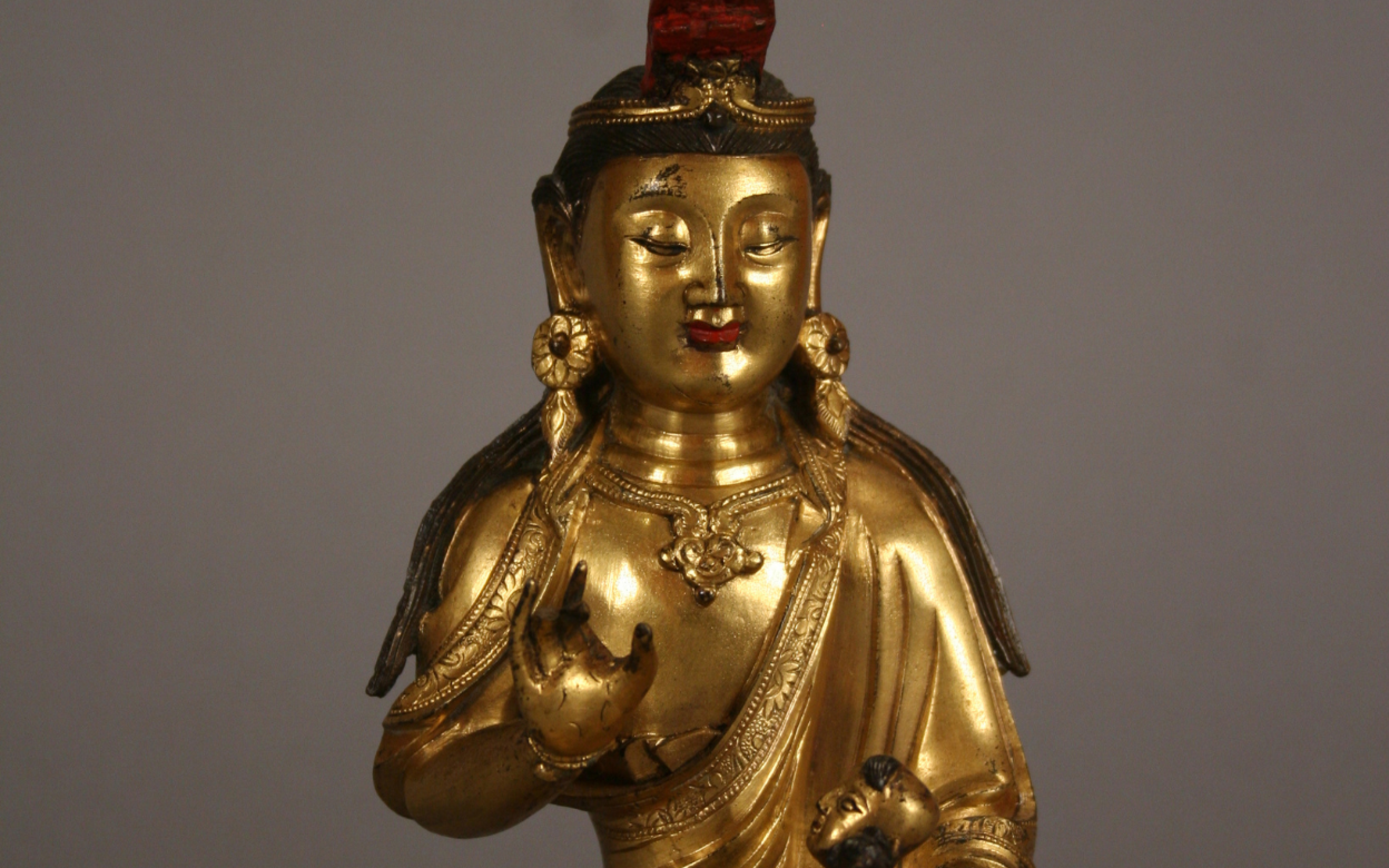 Avalokitshwar in Female Form A bronze statue of a figure in female form holding a baby.