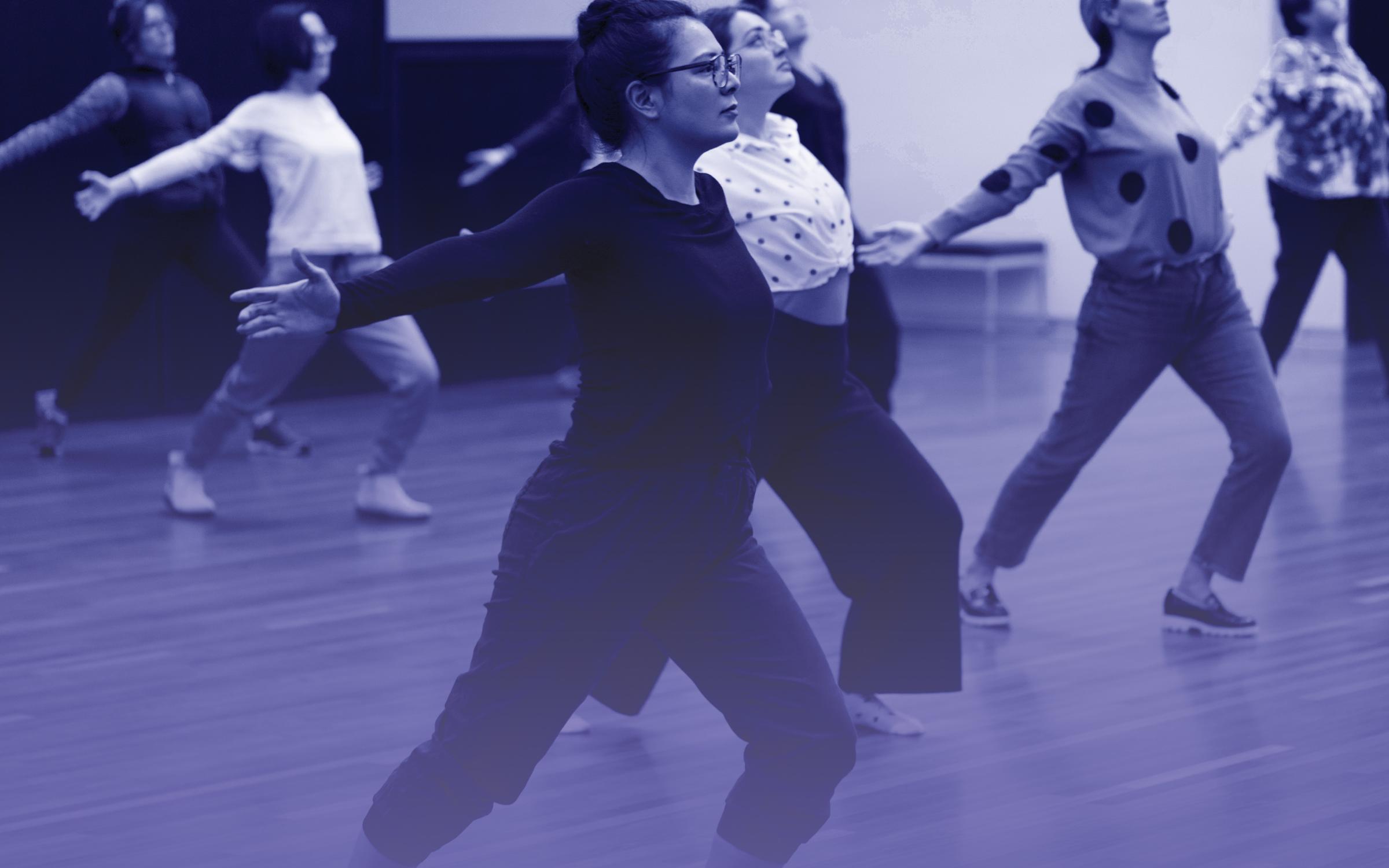 A group of people practice tai chi.