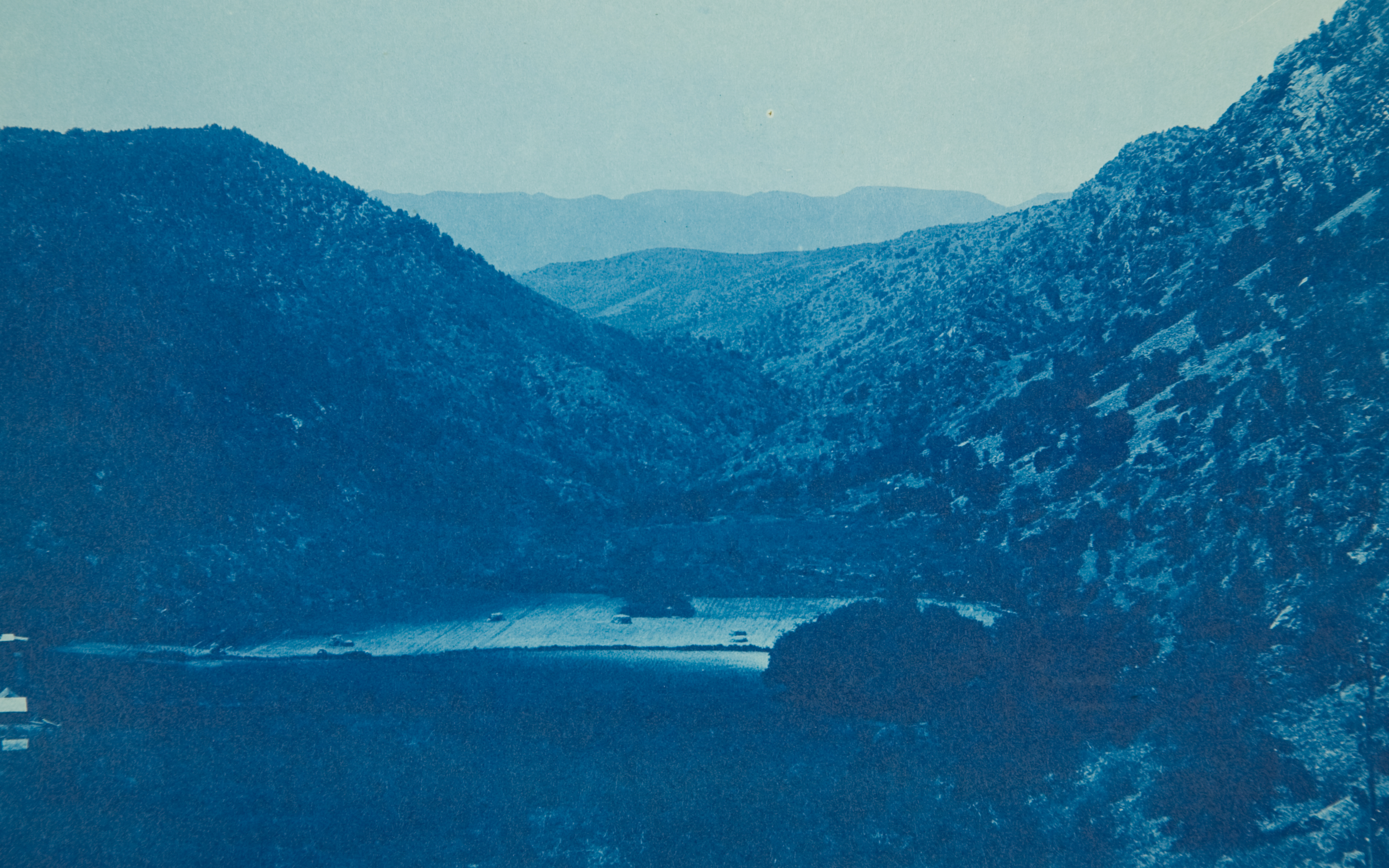 Canon of Pine Creek, Arizona, Territory by Charles Fletcher Lummis A blue cyanotype photo of a valley.