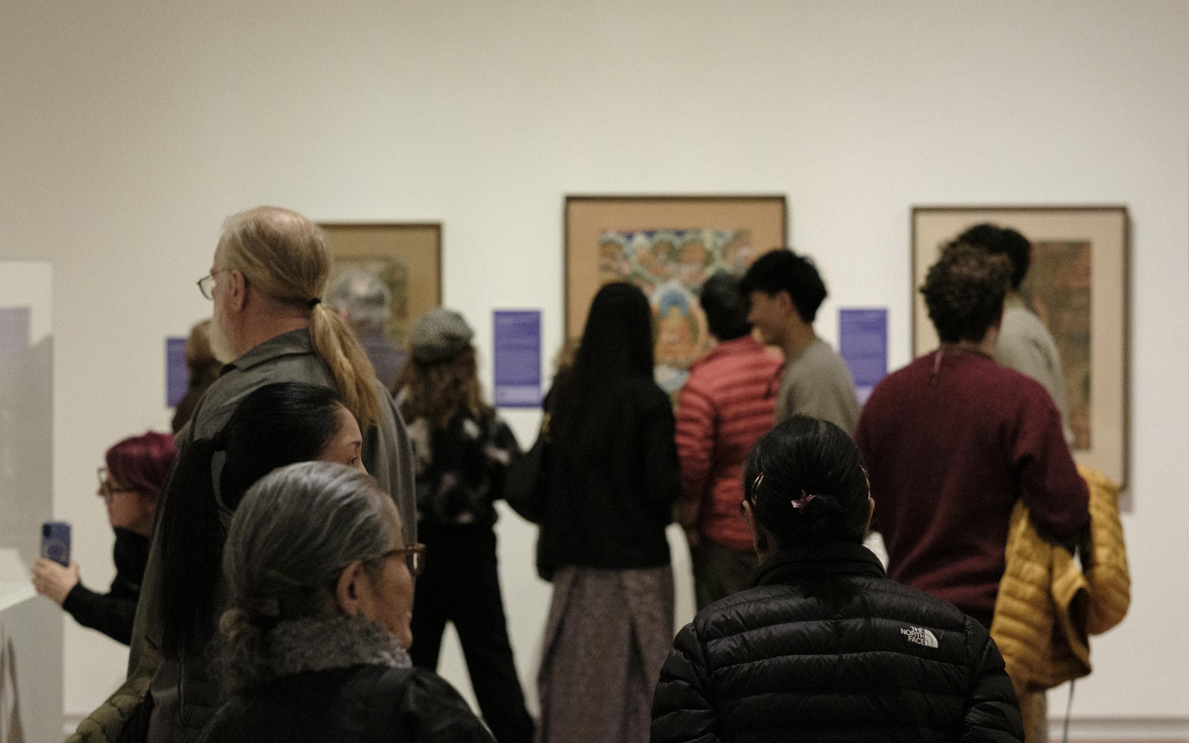 A group of people in a gallery.
