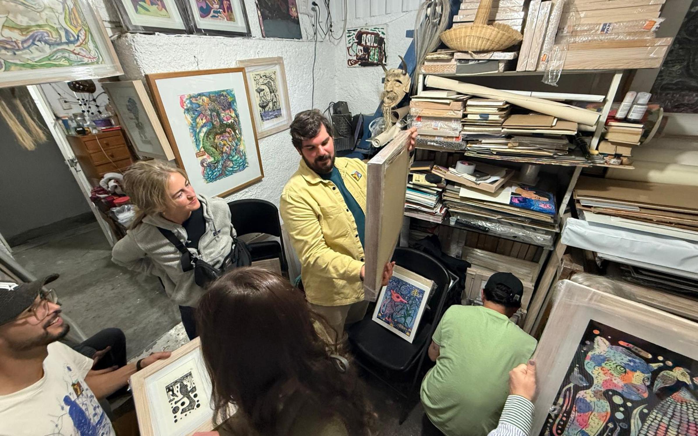 Peter Hay Studio Visit with Filogonio Naxín. Photo by Amy Jorgensen. Peter Hay looking at art in a studio.