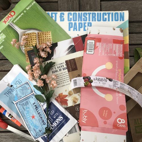 Collected materials for recycled collage, boxes, labels and paper