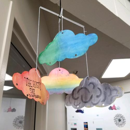 Mobile of flat cut paper clouds painted with watercolors