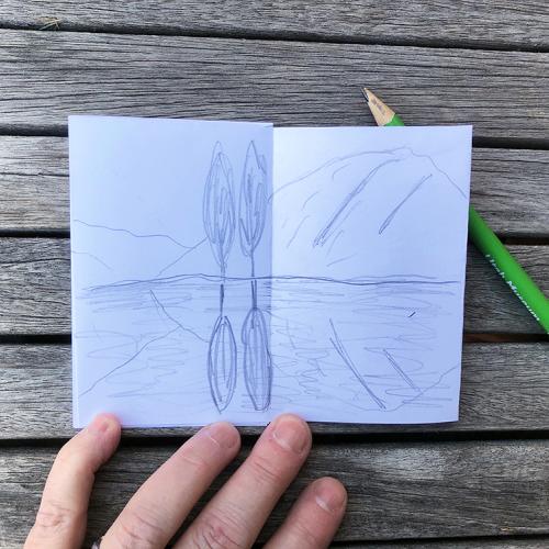 white paper with a drawing of a pond with two trees on the shore reflected in the water