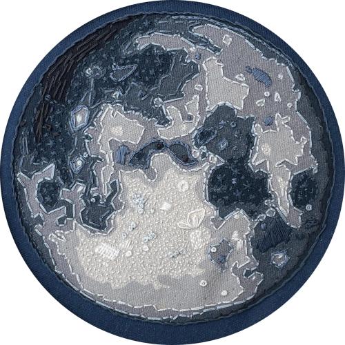 an embroidery of the moon in shades of blue and gray fabric and thread