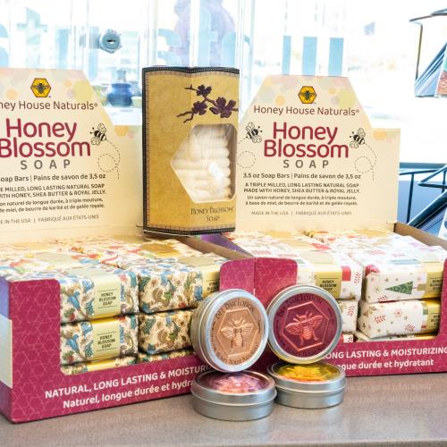 A display of colorfully wrapped bars of soap called Honey Blossom Soap.