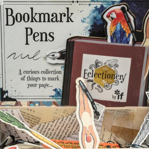 A small box filled with paper art clippings made into ball point pens labeled, "Bookmark Pens".