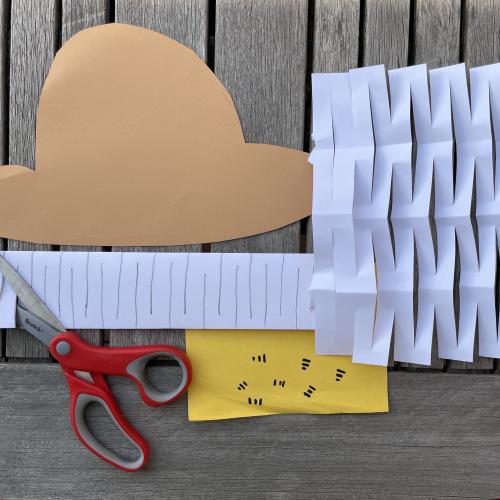 Paper cut into a hat shape and another piece of paper cut into a net shape