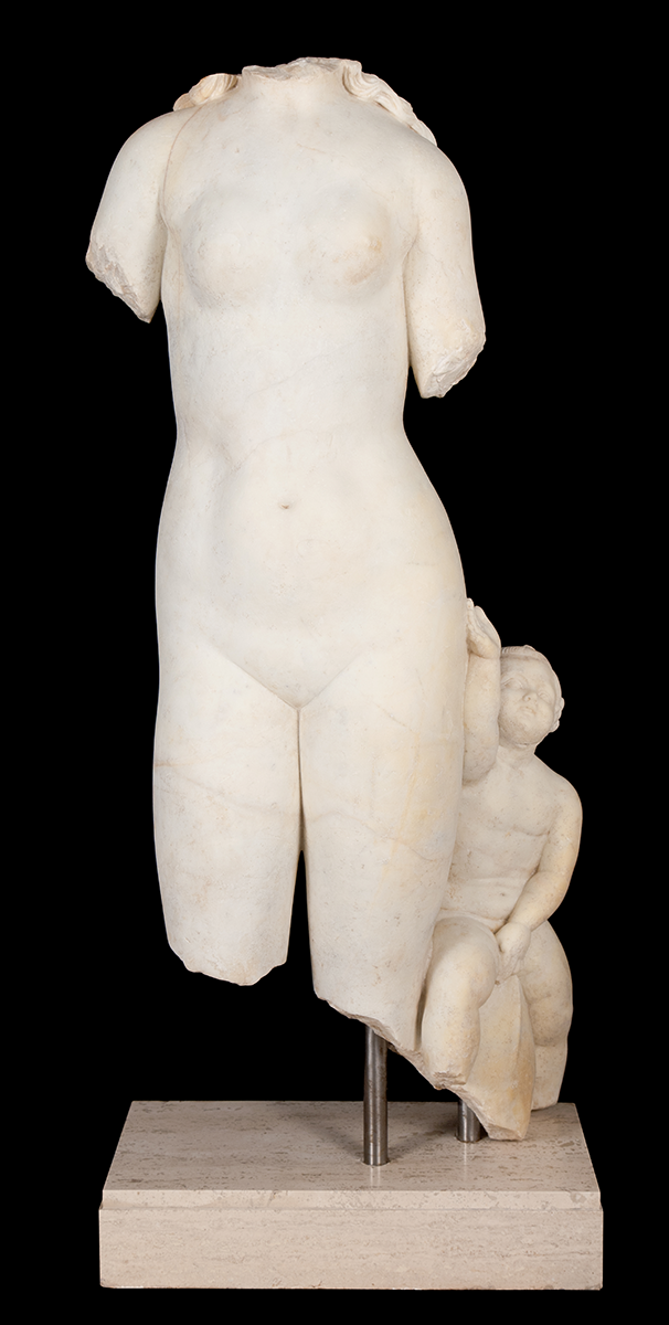 A white marble statue with missing head and limbs.